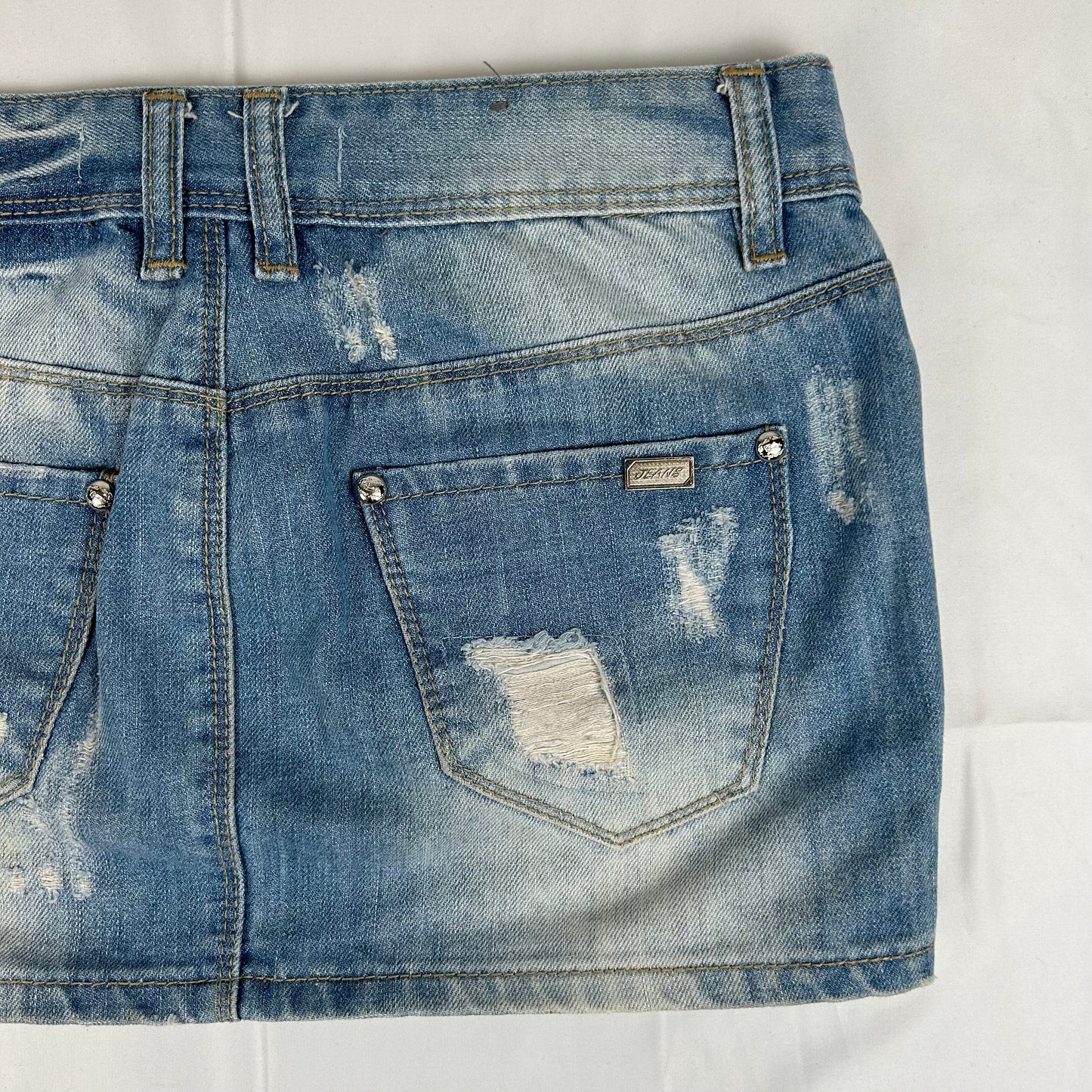 Vintage y2k style distressed denim mini skirt